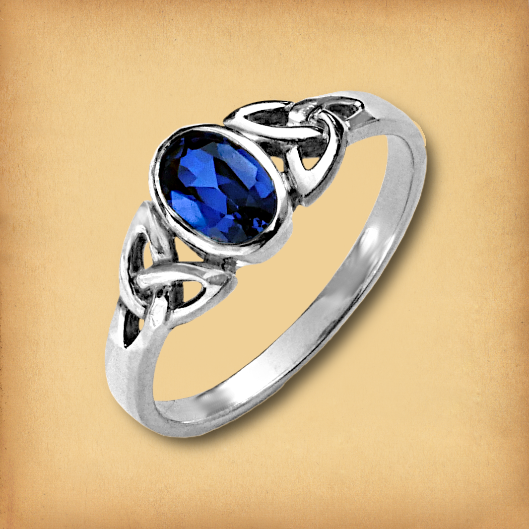 Sterling Silver Sapphire Celtic Ring, featuring a deep blue oval gemstone, elegantly framed by a pair of Celtic knots.