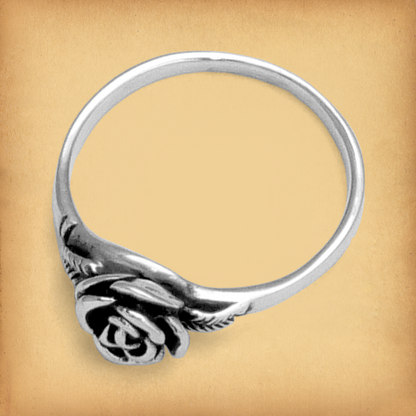 Side view of the Sterling Silver Rose Ring, emphasizing its delicate rose-in-bloom design and minimalistic silver band.