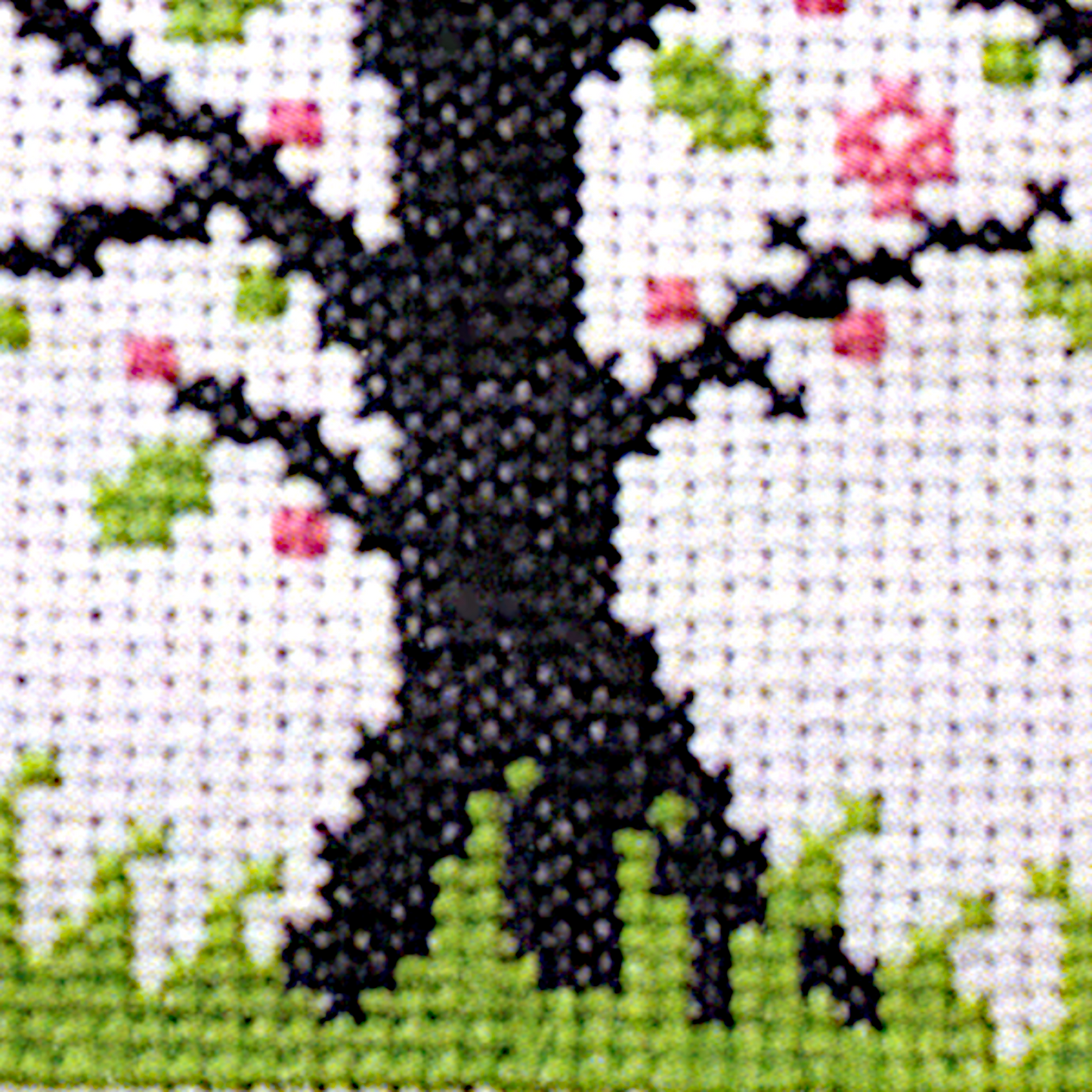 Close-up of a stitched section of the Blessed Ostara cross stitch design, highlighting the vivid pink and spring green colors